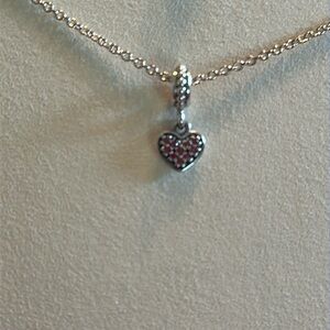 Pandora silver and ruby heart charm.